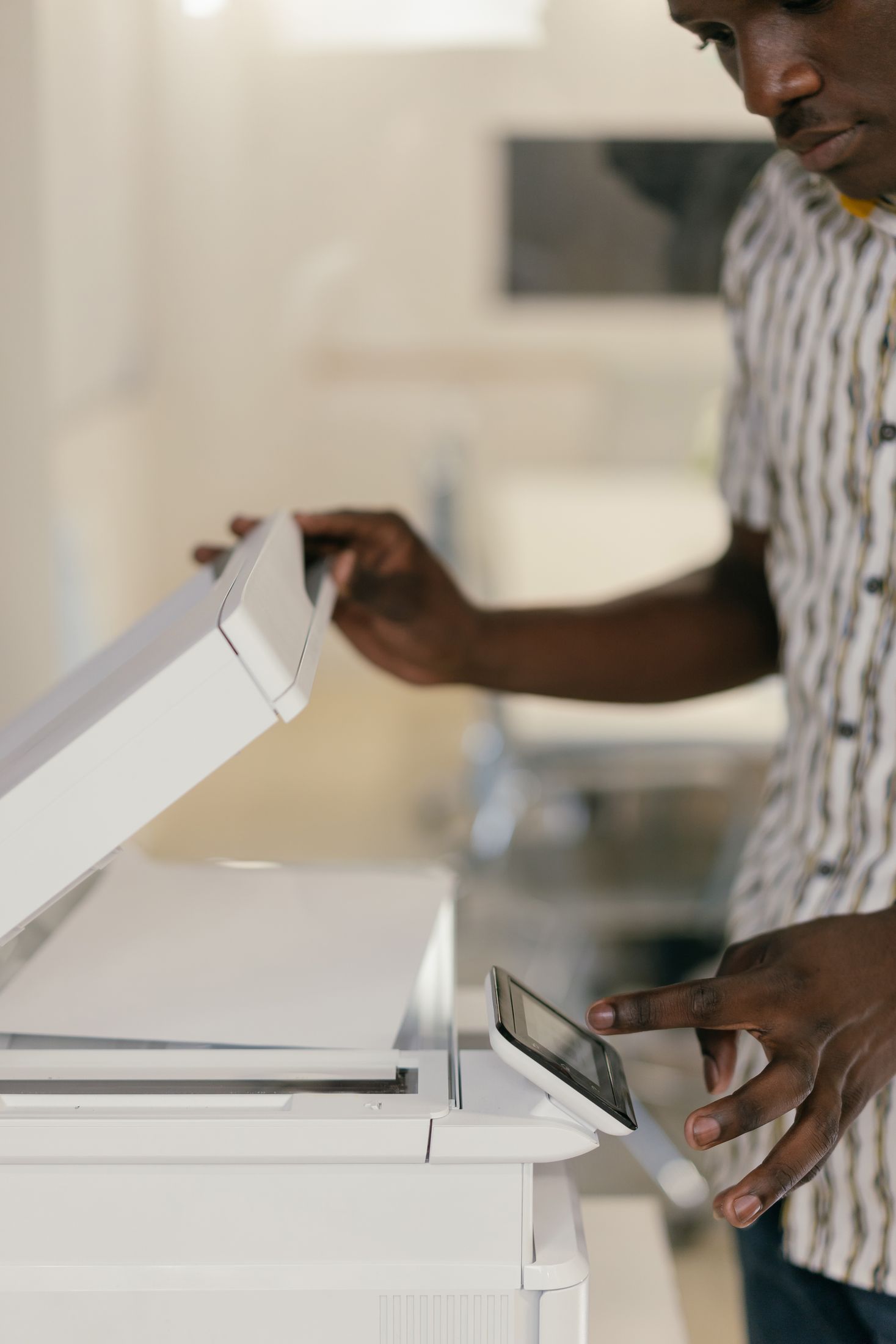 Office worker using a multifunction copier touchscreen